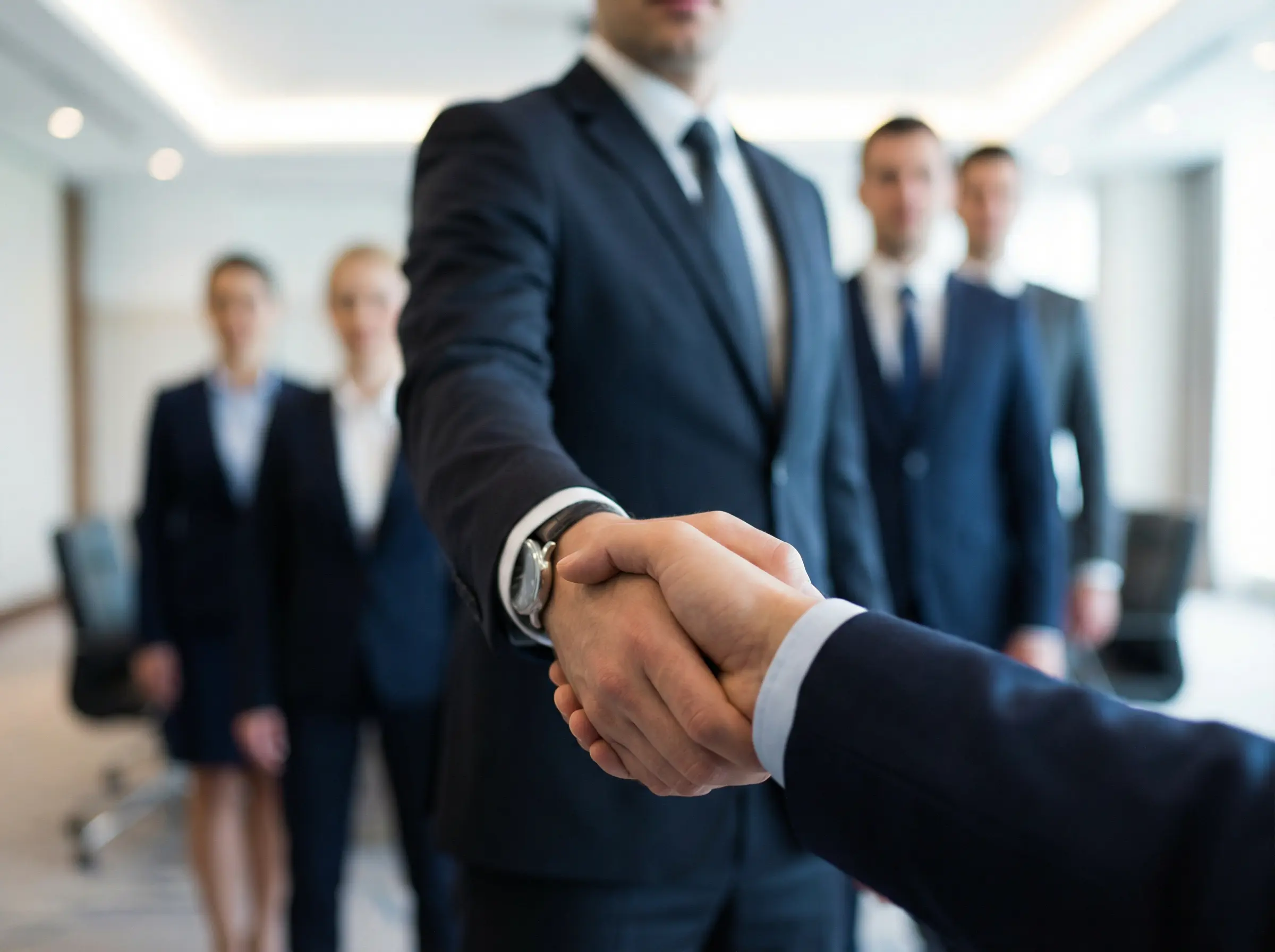 A man in a suite shaking hands